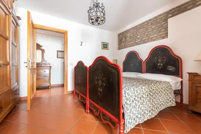 a bedroom with a red bed in a room at Casa Mulaz in Falcade