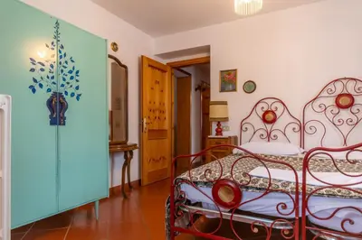 a bedroom with a red bed in a room at Casa Mulaz in Falcade