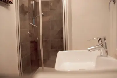 a bathroom with a sink and a shower at Chalet 1897 in Caldaro