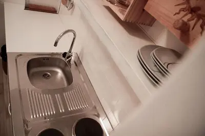 a bathroom with a sink in the corner at Chalet 1897 in Caldaro