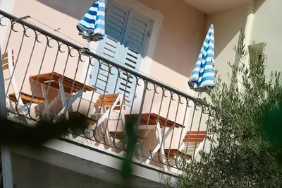 a balcony with tables and umbrellas on a house at Chalet 1897 in Caldaro