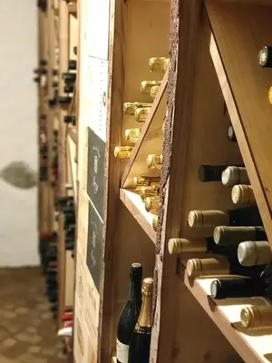 a row of wine bottles in a wine cellar at Chalet 1897 in Caldaro