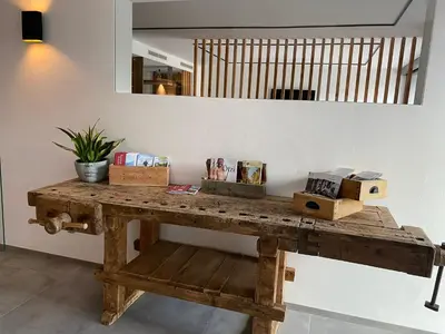 a wooden table with boxes on it in a room at Hotel Garni Vinea Montis in Termeno