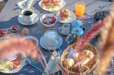 a table with breakfast foods and coffee on it at Hotel Garni Vinea Montis in Termeno