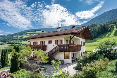 a large house with balconies on a mountain at Turnerhof in Bressanone