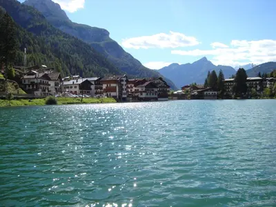 a large body of water with houses and mountains at Hotel Adriana in Alleghe
