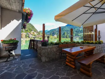 a patio with a table and chairs and a view at Hotel Adriana in Alleghe