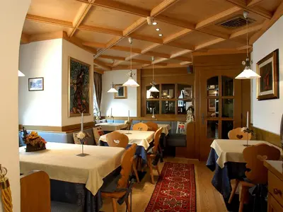 a restaurant with tables and chairs in a room at Hotel Adriana in Alleghe