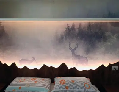a painting of deer on the wall next to a bed at Atelier La Stube - Alpine Design Home in Bolzano