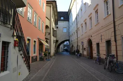 an alley in an old town with bikes parked on the street at Atelier La Stube - Alpine Design Home in Bolzano