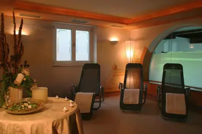 a room with a table and chairs with a table at Hotel Laurin in Lagundo
