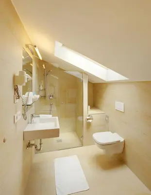a bathroom with a sink and a toilet and a shower at Hotel Laurin in Lagundo