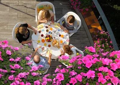 a group of people sitting around a table with food at Hotel Laurin in Lagundo