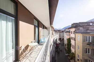 an apartment balcony with a view of a street at Stay COOPER l Capitol Rooms in Bolzano