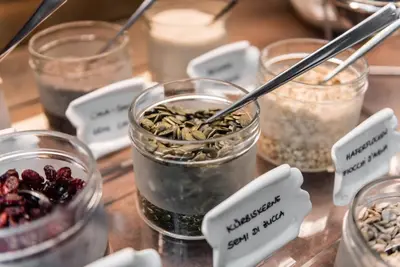 a group of jars filled with different types of food at Romantik Hotel & Restaurant Stafler in Vipiteno
