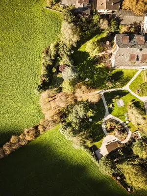 an aerial view of a house and a field of grass at Romantik Hotel & Restaurant Stafler in Vipiteno