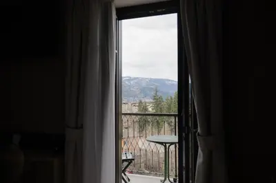 a bottle of wine and a glass on a table at Hotel Orso Grigio in Cavalese