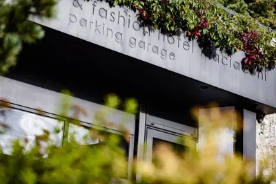 a building with a sign that reads a fascist hospital parking garage at Boutique & Fashion Hotel Maciaconi - Gardenahotels in Santa Cristina in Val Gardena