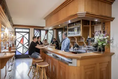 a group of people sitting at a bar at B&B Villa Pattis in Vipiteno