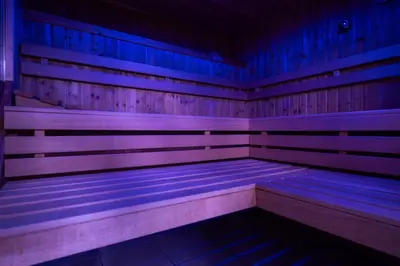 a wooden sauna with purple and blue lights at B&B Villa Pattis in Vipiteno