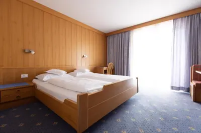 a bedroom with a large bed in a room at Garni Juval in Tirolo