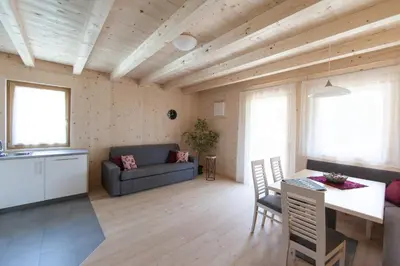 a living room with a couch and a table at Winklerhof Apartments in Brunico