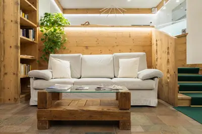 a living room with a couch and a coffee table at Hotel Montana in Cortina dʼAmpezzo