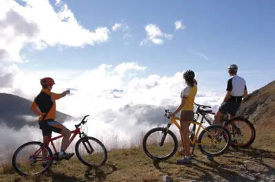 a group of three people on bikes on a mountain at Hotel Mirabel in San Vigilio Di Marebbe