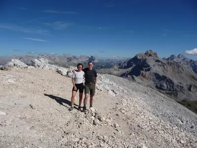 a man and a woman standing on top of a mountain at Hotel Mirabel in San Vigilio Di Marebbe