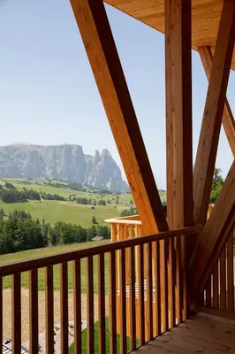 a view of the mountains from the porch of a cabin at ICARO Hotel in Alpe di Siusi