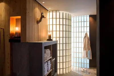 a room with a large window and a shelf with towels at ICARO Hotel in Alpe di Siusi