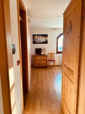 a hallway with a door leading to a living room at Casa del Cirmolo - apartments for rent in Cavalese