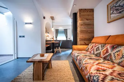 a living room with a couch and a table at Apartments Smidl in Ortisei