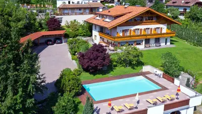 an aerial view of a house with a swimming pool at Pension Golser in Cermes