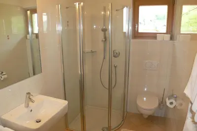 a bathroom with a shower and a toilet and a sink at Pension Golser in Cermes