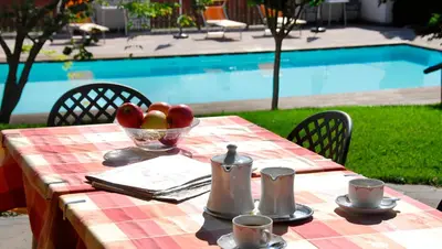 a table with a bowl of apples and a bowl of fruit at Pension Golser in Cermes