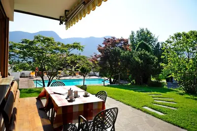 a patio with a table and chairs and a pool at Pension Golser in Cermes