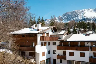 a white building with snow on top of it at Villa Franchetti - Stayincortina in Cortina dʼAmpezzo