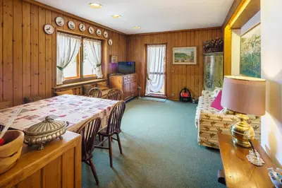 a living room with a table and a couch at Villa Franchetti - Stayincortina in Cortina dʼAmpezzo