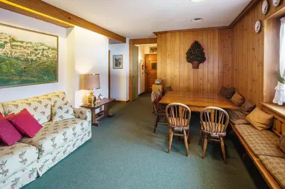 a living room with a couch and a table at Villa Franchetti - Stayincortina in Cortina dʼAmpezzo