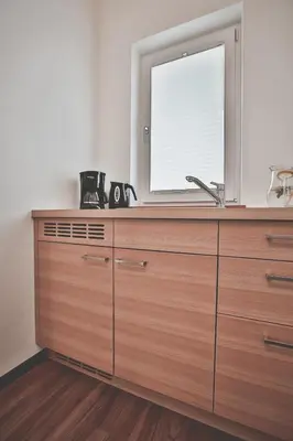 a kitchen with a large wooden dresser with a window at Seppmair in Lagundo