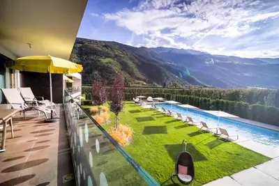a balcony with a view of a pool and mountains at Residence & Sportlodges Claudia in Plaus