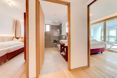 a large mirror in a room with a bedroom at Residence & Sportlodges Claudia in Plaus