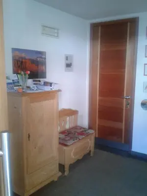 a room with a wooden cabinet and a door at Apartments Haus Martin in Nova Levante