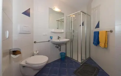 a bathroom with a toilet and a sink and a shower at Apartments Haus Martin in Nova Levante