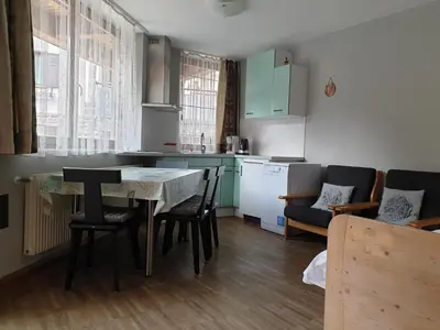 a kitchen with a table and chairs in a room at Apartments Haus Martin in Nova Levante