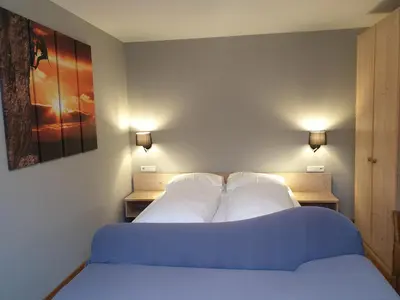 a bedroom with a bed with two white pillows at Apartments Haus Martin in Nova Levante