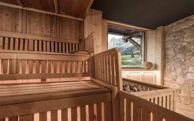 an empty sauna with a window in a cabin at Hotel Alpenrose in Carezza al Lago