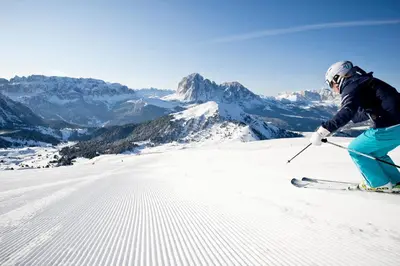 a person is skiing down a snow covered mountain at Hotel ANDER in Brunico