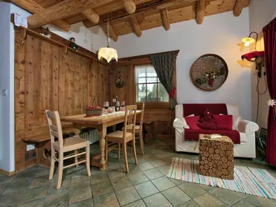 a living room with a table and a couch at Typical Cottage in Bellamonte Italy with bubble bath in Bellamonte
